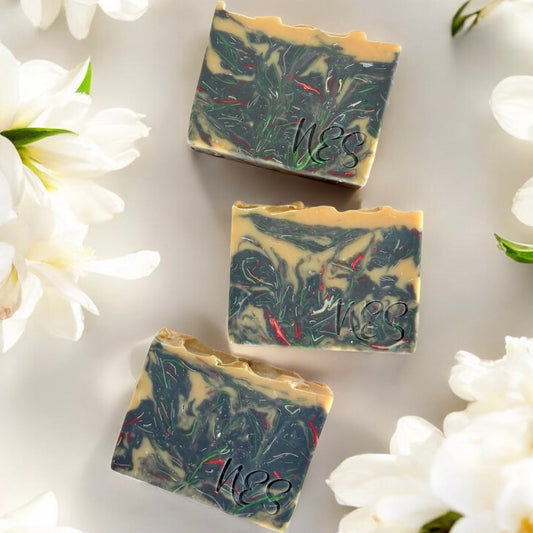 NES Midnight Bloom artisan soap bar surrounded by white flowers - scented with bergamot, gardenia, jasmine and sandalwood.