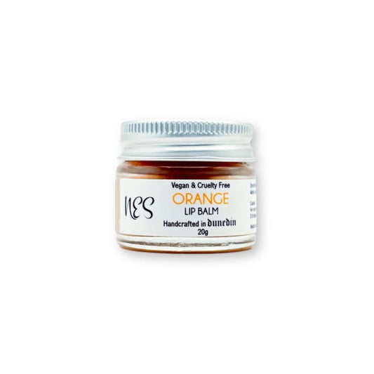 NES Orange Lip Balm in a small glass jar with a silver lid, handcrafted in Dunedin, NZ. Vegan, cruelty-free, and enriched with nourishing oils for soft lips.