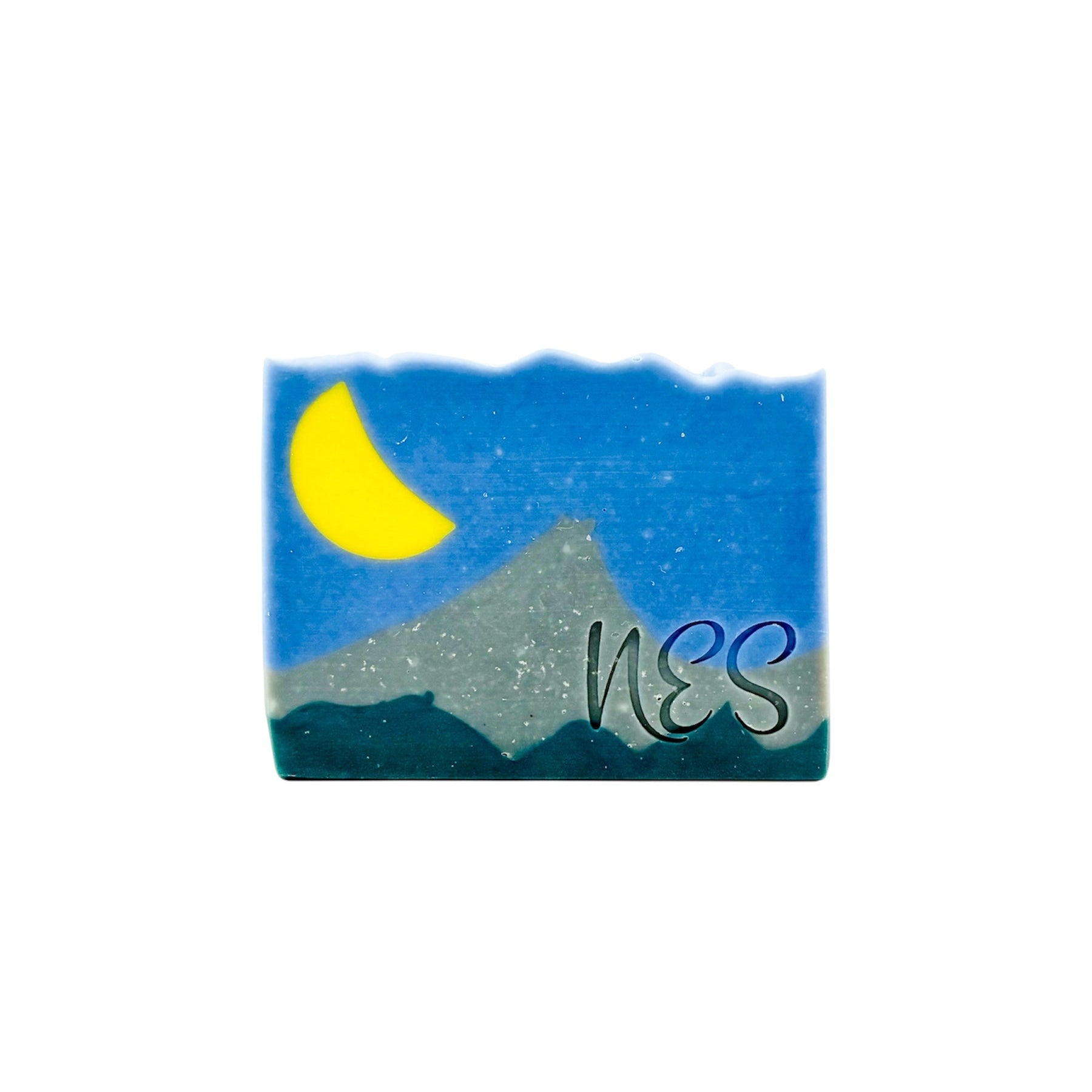 Front view of NES Soap’s Silver Peaks artisan soap, showcasing a handcrafted night sky and mountain landscape design with a crescent moon.