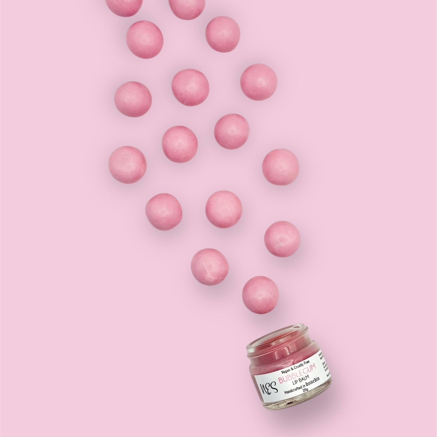 Bubblegum lip balm with pink bubblegum candies – fun, moisturizing, and vegan lip care by NES Soap NZ.