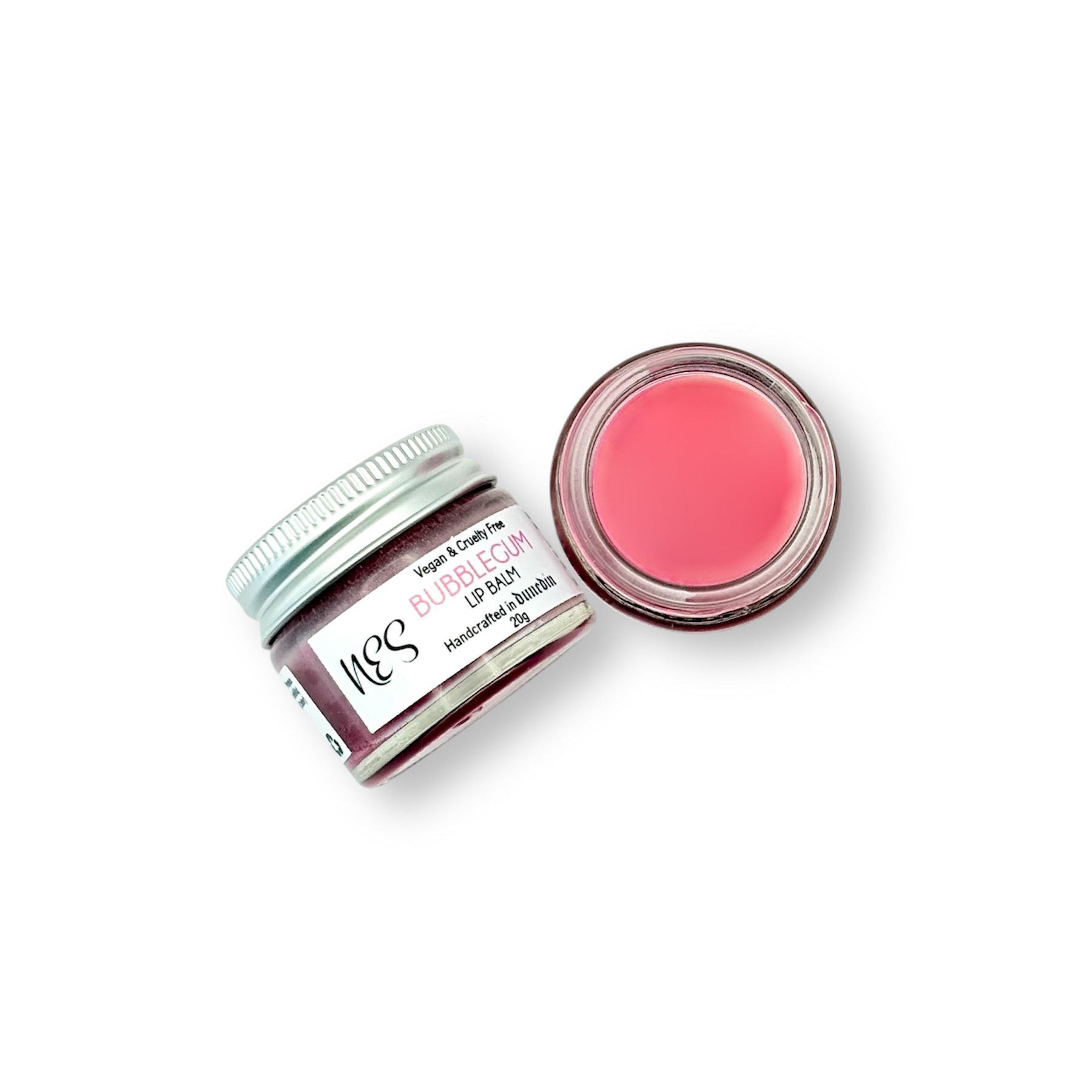 Bubblegum lip balm in an open glass jar showing its pink tint – hydrating and nourishing lip care from NES Soap NZ.