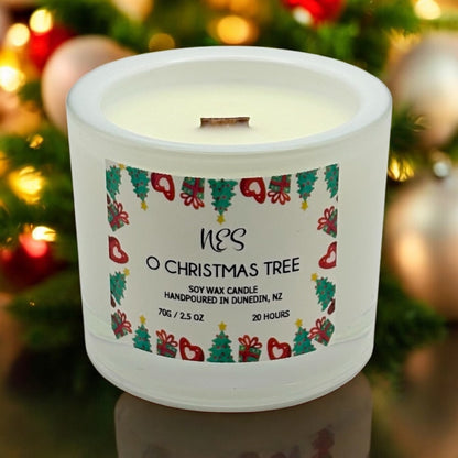 Decorative candle with Christmas design in front of a decorated tree. Handpoured in Dunedin, NZ by NES Soap