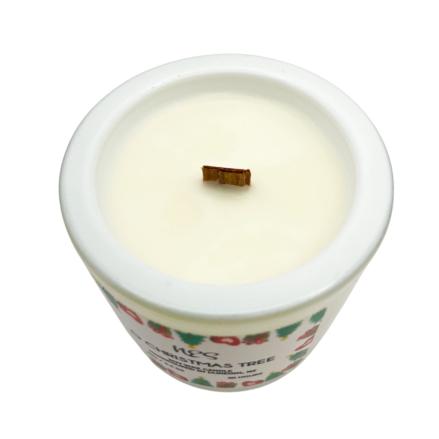 Candle in a decorative container with a Christmas tree design on a white background. Soy wax, wood wick, handpoured in Dunedin, NZ by NES Soap