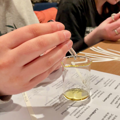 Dropping fragrance oil to make perfume at NES Soap perfume workshop in Dunedin, NZ.
