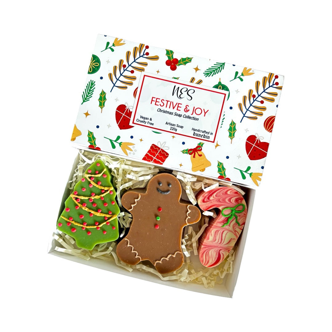 Box of Christmas-themed soap with a decorative box labeled 'NES Festive Joy'. Vegan and cruelty free Christmas soap collection, handmade in Dunedin, NZ by NES Soap