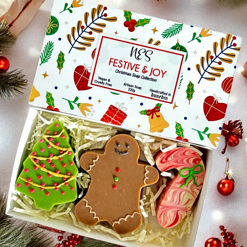 Christmas-themed soap set with decorative packaging on a festive background. Vegan and cruelty free, handmade in Dunedin, NZ by NES Soap