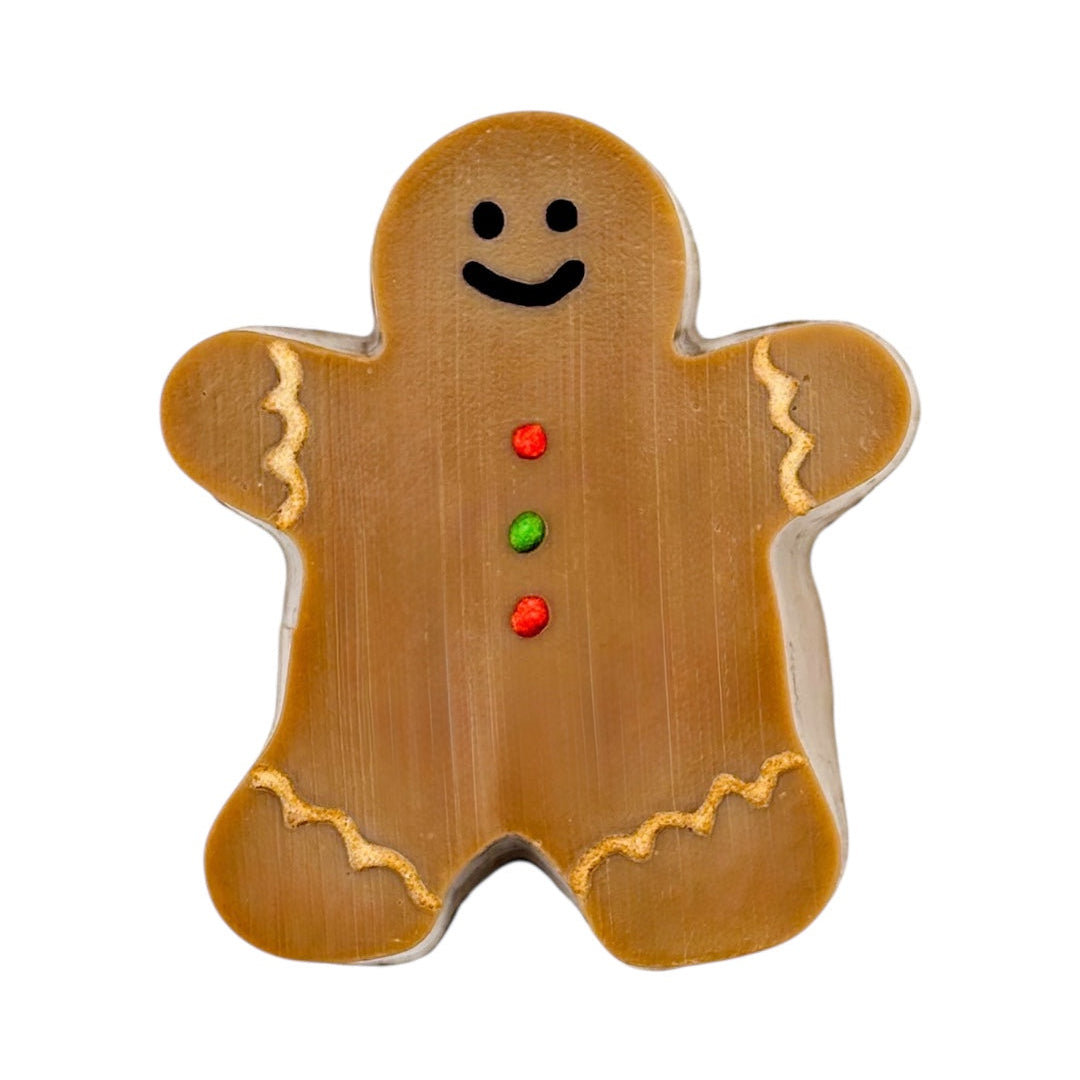 Gingerbread man soap with a smiley face on a white background. Vegan and cruelty free Christmas soap, handamde in Dunedin, NZ by NES Soap.