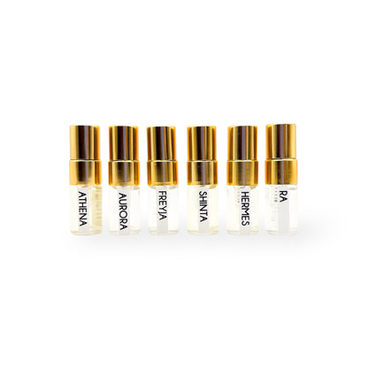 Set of six NES Soap mini perfume bottles with gold caps, each labeled with unique fragrance names. Vegan, cruelty-free perfumes made in New Zealand.