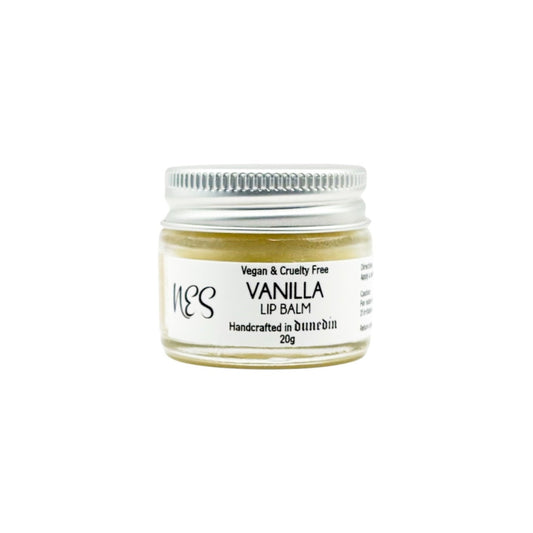 Front view of NES Soap vanilla lip balm in a small glass jar, handmade vegan lip care made in New Zealand.