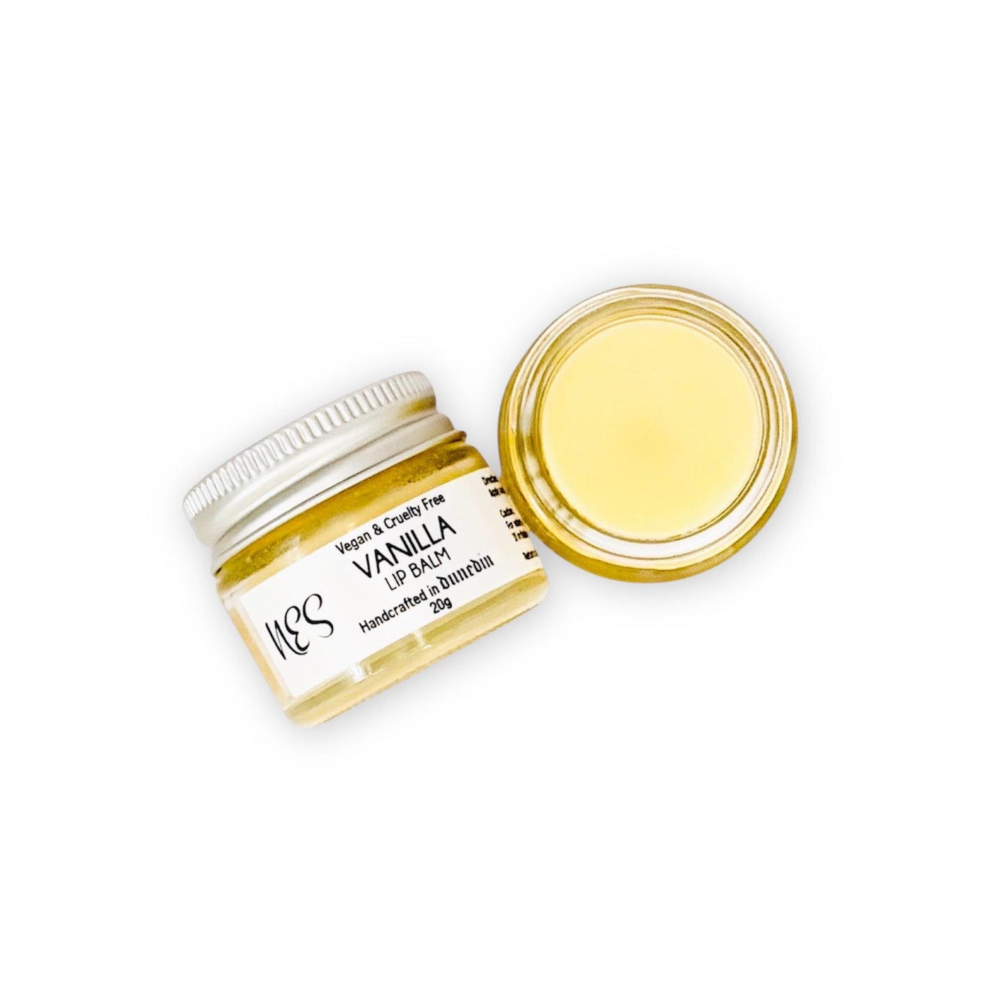 Open jar of NES Soap vanilla lip balm with creamy texture, natural and cruelty-free lip care in glass packaging.