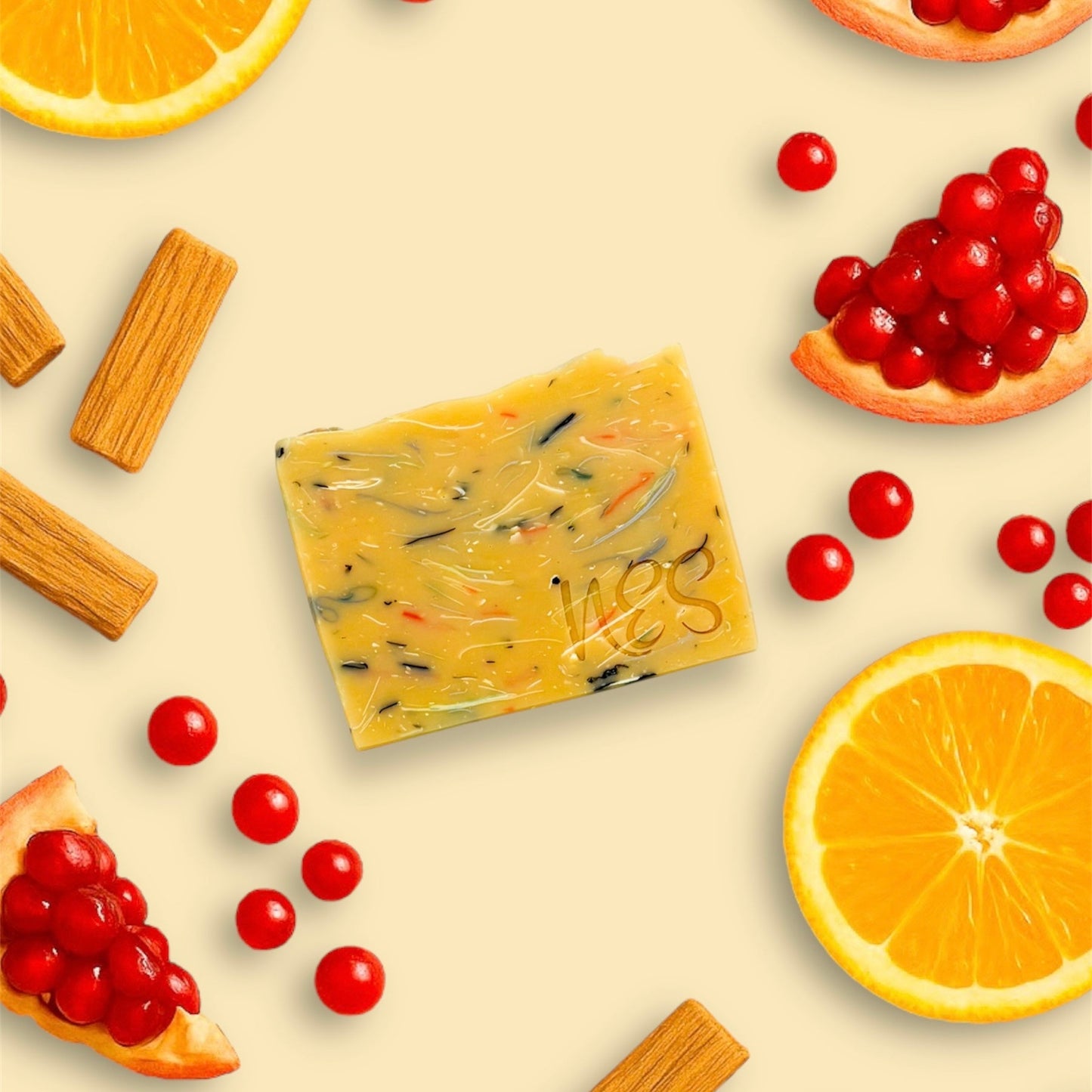 Flat lay of NES Wild Orchard Artisan Soap with orange, pomegranate, red currant, and sandalwood – vibrant natural ingredients surround the handcrafted soap.
